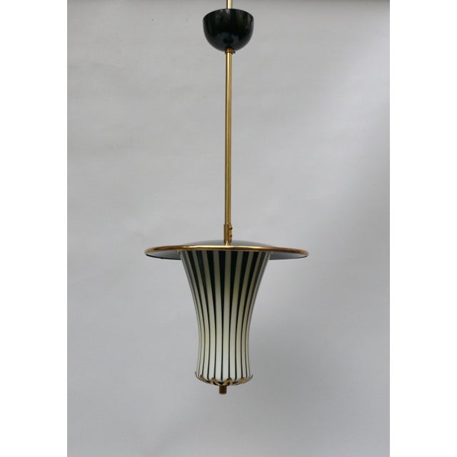 A pair of exceptional "Lantern" ceiling lights, made in Italy in the 1950s in the Stilnovo style. They feature an elegant...