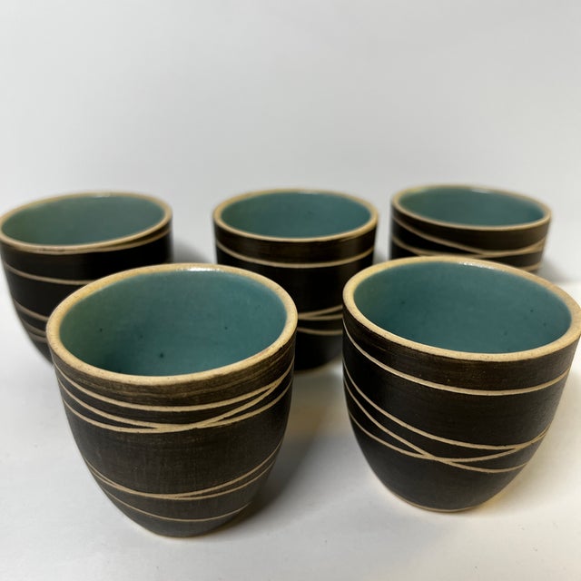 Lovely set of five ceramic glazed sake cups. Grey glaze incised on the outside, turquoise on the inside. Signed by the...