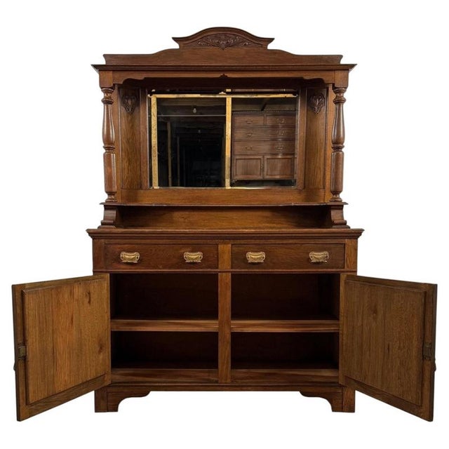An impressive early 20th-century English sideboard, finely crafted from oak and distinguished by its substantial mirrored...