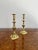 Pair of antique Victorian brass candlesticks having a pair of antique Victorian brass candlesticks with a turned shaped...