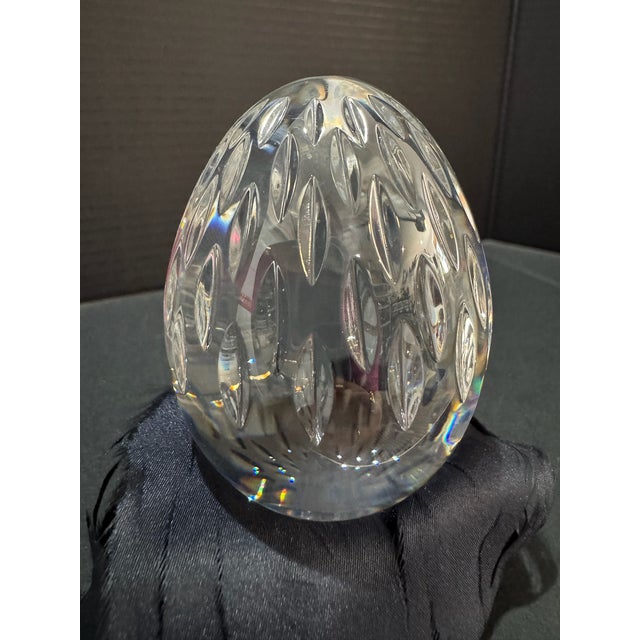 Clear cut crystal egg paperweight by Baccarat with classic faceted surface and elegant minimalist form. Decorative on a...