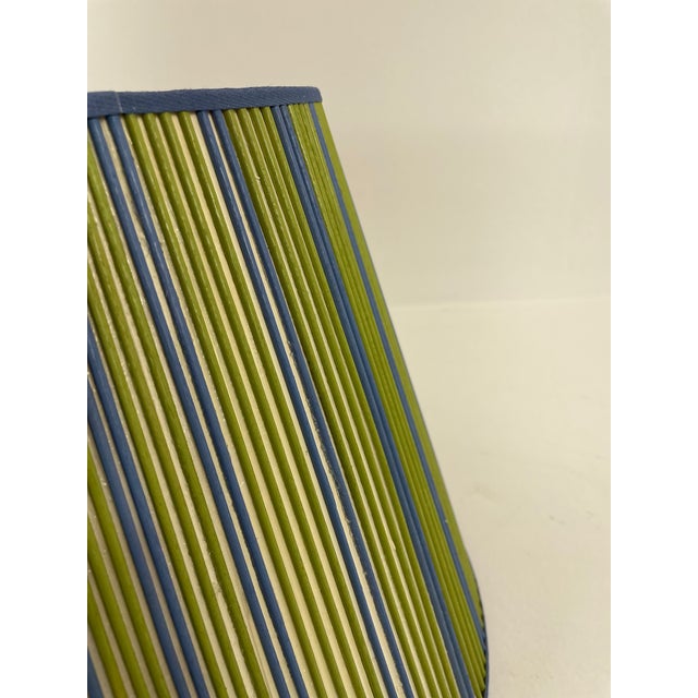 Green and blue painted sticks are added by hand, one at a time, over artisanal, vellum paper. This Stick Shade will add...