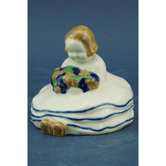 Item description: Delightful soft ceramic sculpture, decorated by hand and with an airbrush, depicting a little girl...
