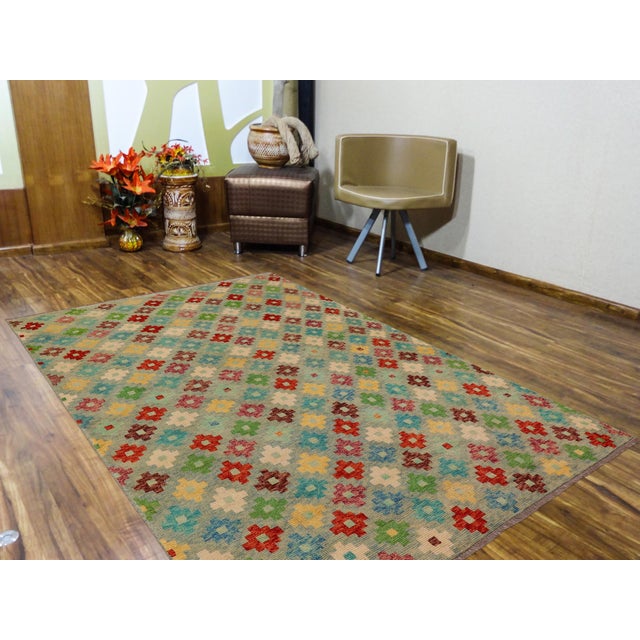 This stunning hand-knotted Afghan Balouchi rug is a captivating addition to any decor. Crafted by skilled artisans, it...