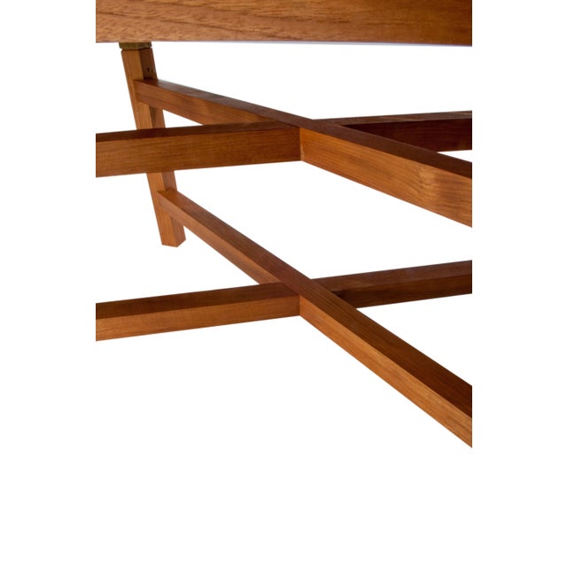 A solid teak wood rectangular dining table by Donghia features a removable slat style top with solid brass leg hardware,...