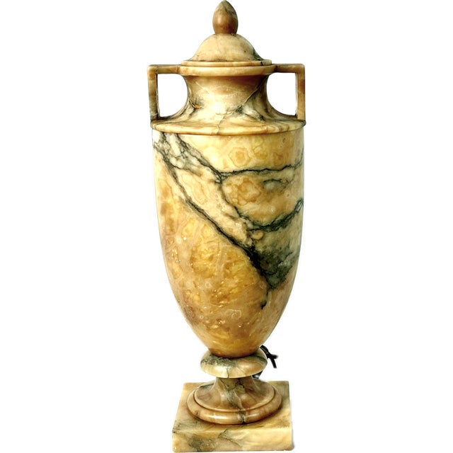 Stunning pair of 20th century alabaster Italian urn table lamps. Lamps feature the classic ornate urn shape and are...