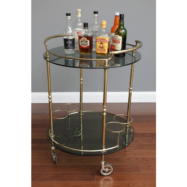 Vintage brass food trolley with glass shelves and rubber-coated swivel wheels. In perfect condition. No chips on the...