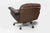 A substantial and highly comfortable mid-century modern swivel lounge chair, featuring a generous, low-slung form...