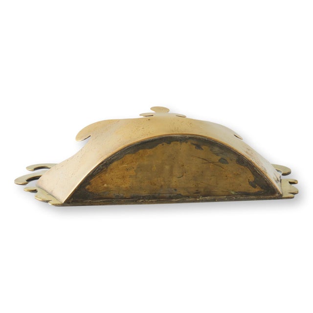 Late 19th century English wall pocket cut and pierced from solid brass in a stylized crown motif. Known as a tidy, this...
