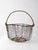 Antique handmade wire gathering basket dating from the 1920s–1940s, featuring a classic primitive farmhouse form and...