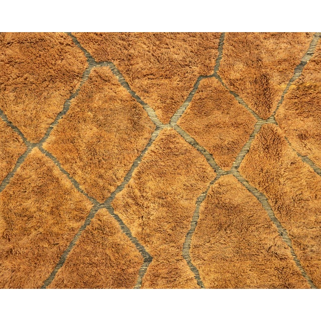 A vast field of sun-baked earth, traced with a whisper of diamonds. This hand-knotted wool rug spans a monumental scale in...
