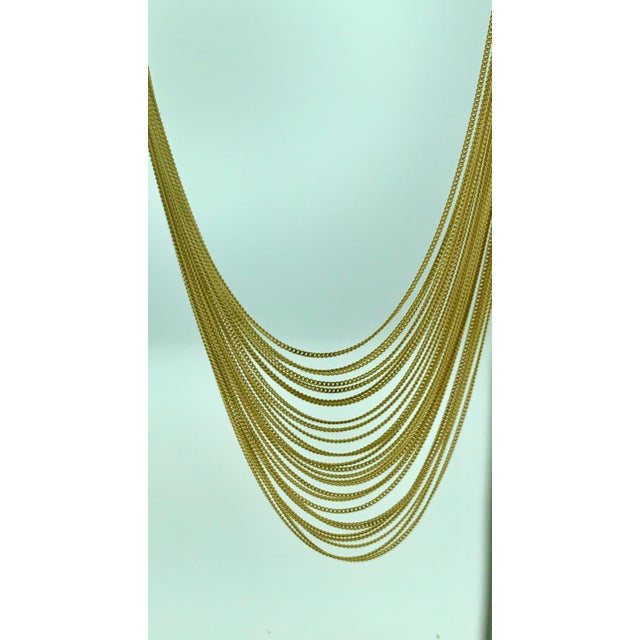 100 Gm 18 Karat Yellow Gold Necklace By Designer Gucci , Opera Length Graduating lariat with 27 multi strand gold chains,...