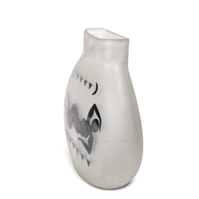 Stunning Art Glass vase depicting a stylized female in repose, executed in glossy black relief finish on an off white...