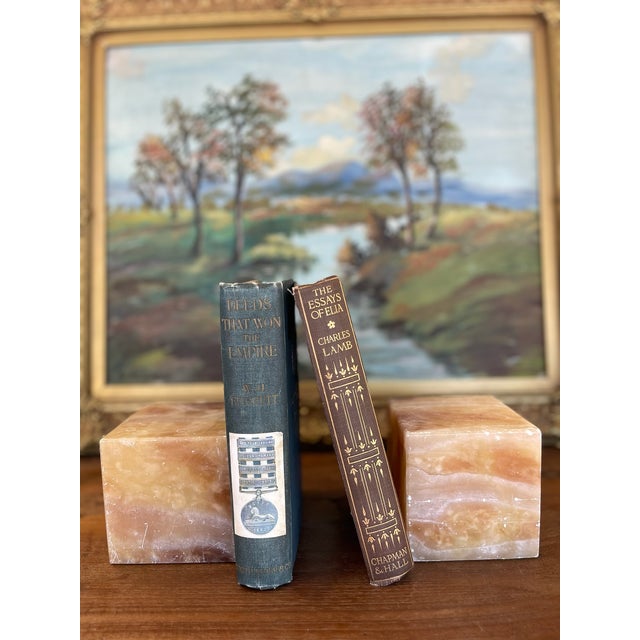 This striking pair of mid-century bookends is hand-carved from what is likely solid peach onyx, also commonly referred to...