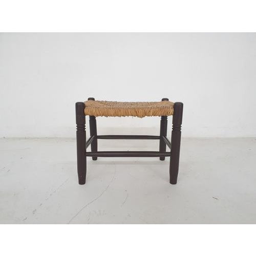 About this item Small wooden (foot) stool with rattan seating. The wood has been painted dark brown.