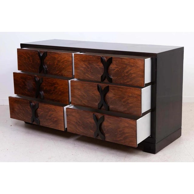 1940s Modernage walnut six-drawer dresser in the manner of James Mont with elegant rosewood "X" shaped pulls. Starburst...