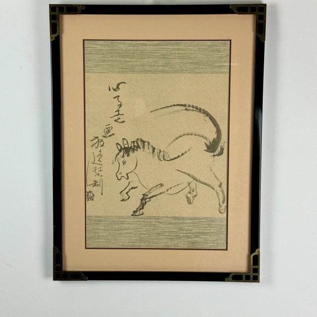 A minimalist watercolor on paper painting of a Han Dynasty prancing horse in a field. It's framed and ready to hang. We...