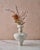 The "Lydion Granito" Decorative Vase by Canoa Lab is a handcrafted stoneware vase inspired by the timeless forms of...