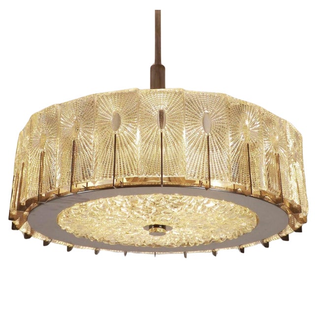 Illuminate your interior with timeless elegance through this extraordinary mid-century chandelier, crafted by renowned...