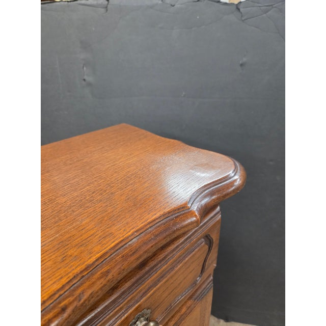 This Vintage Oak French Style 2 Door Cabinet With Drawer has a nice curved shaped top and brass escutcheons. It would look...