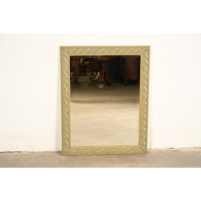 A gorgeous Italian Regency Louis XVI style wall mirror In the manner of John Widdicomb Italy, Circa Late 20th Century...