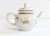 An antique, 18th-century Chinese export porcelain teapot for the European market in a classical shape and a rust and gold...