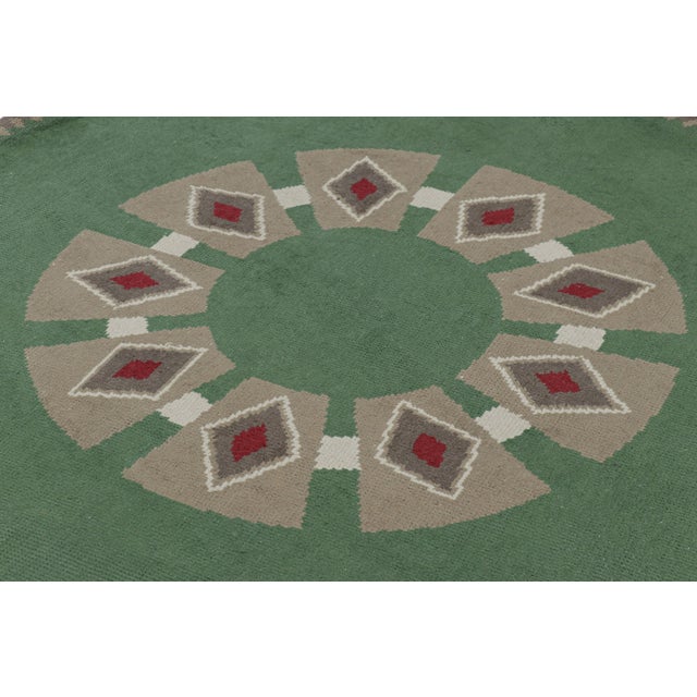 Made with hand-knotted wool in France circa 1950, this 6x6 vintage French Art Deco rug is an extremely collectible mid-...