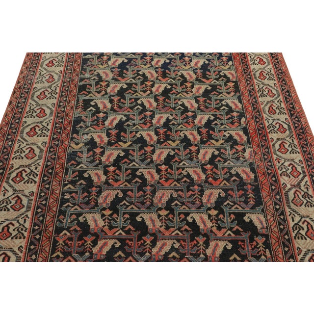 Made with hand-knotted wool circa 1910-1920, this 4x7 vintage Persian rug of Malayer provenance is an exciting new...