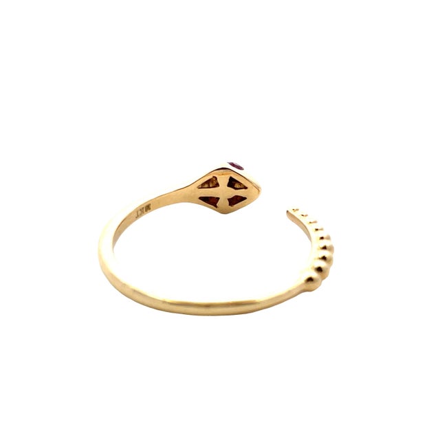 Striking 18K yellow gold serpent open ring designed in a rattlesnake style, featuring vivid ruby eyes totaling...