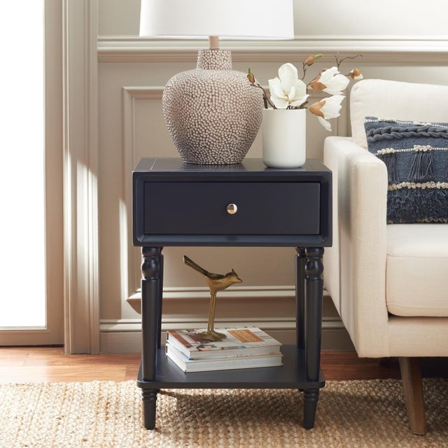 Elevate your living space with the stylish Siobhan accent table. Crafted from a duo of wood and MDF, complemented by sleek...