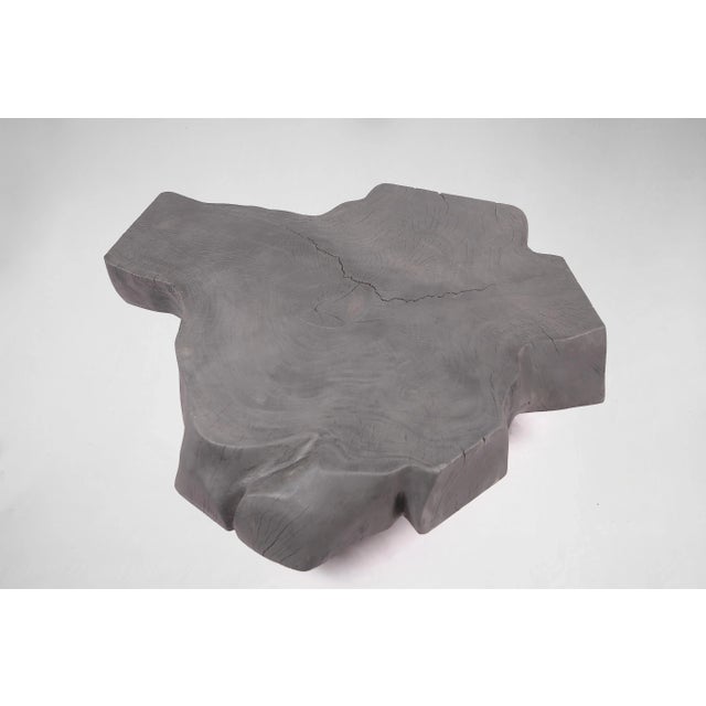 This organic coffee table is handcrafted from one piece of suar wood. The top is flatted, sanded and polished while the...