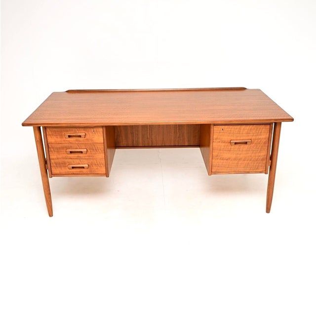 An absolutely stunning and extremely well made vintage Swedish walnut desk by Goran Strand for Lelangs Mobelfabrik. This...