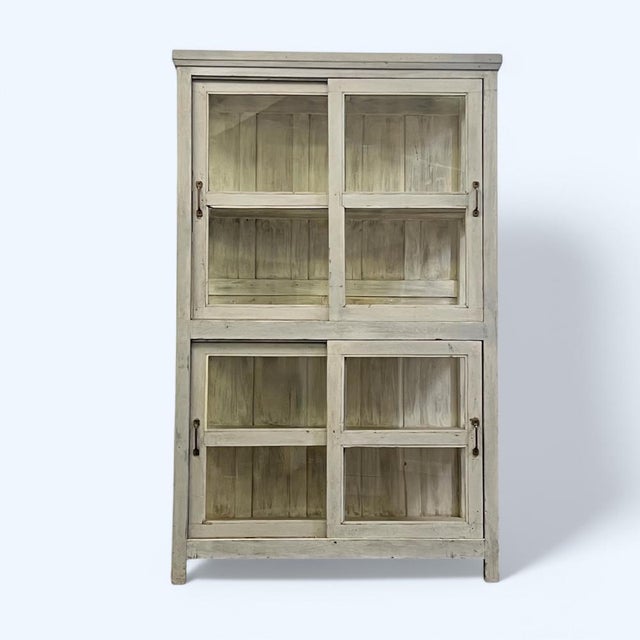 A Large Vintage Indian Glazed Storage Cupboard. Consisting of glazed sides with the upper and lower sections having glazed...