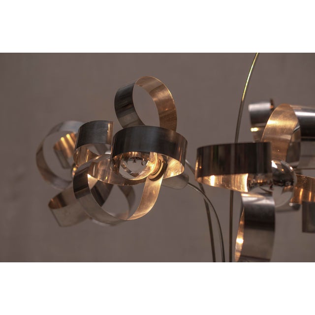 Rare Space Age floor lamp. Characteristic piece made out of a black patinated metal base with stainless steel stylized...