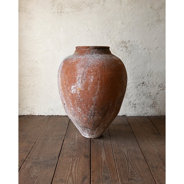 This large antique Mediterranean terracotta olive jar dates from the late 19th to early 20th century and showcases the...