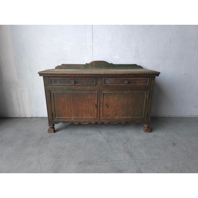 This antique cabinet exudes a kind of charm and timeworn character that can only come from centuries of use. Crafted from...