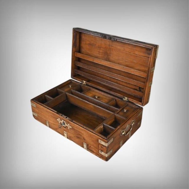 This Anglo-Indian letter chest features a beautiful solid teak construction accented by a band on the front. The front is...
