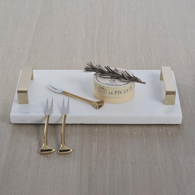 A luxurious blend of natural stone and metallic accents, this marble tray exudes understated elegance. The smooth white...