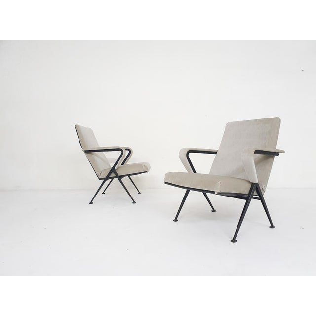 Black metal lounge chairs with new beige velvet upholstery. Designed by the Dutch Designer Friso Kramer for Ahrend de...
