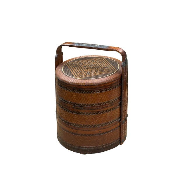 This is a beautiful vintage Chinese stacking basket, crafted primarily from warm-toned, reddish-brown rattan and bamboo....