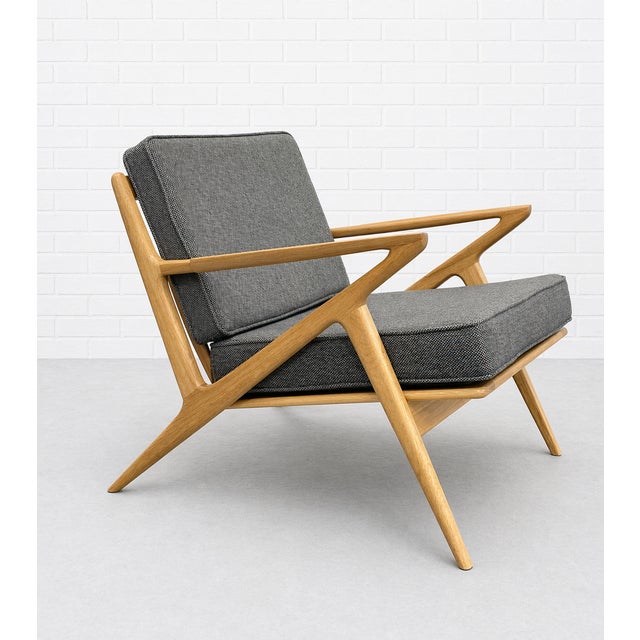 Handcrafted in solid oak, this Mid Century Modern lounge chair showcases exceptional design and detail. The sculptural...