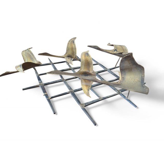 Add a touch of mid-century elegance to your home with this striking 3D brass wall sculpture. Featuring gracefully...