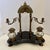 An antique double inkwell desk set featuring two cut-glass ink pots with brass lids and an arch - style swing - frame that...
