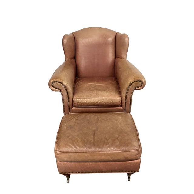 Vintage leather wingback lounge chair and matching ottoman by Milling Road, a division of Baker Furniture. The set...