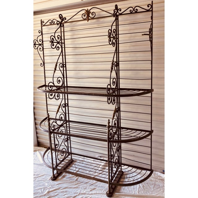 Antique French bakers rack late 19th century scrolling shelf dividers brass accents throughout heavy iron feet at bottom
