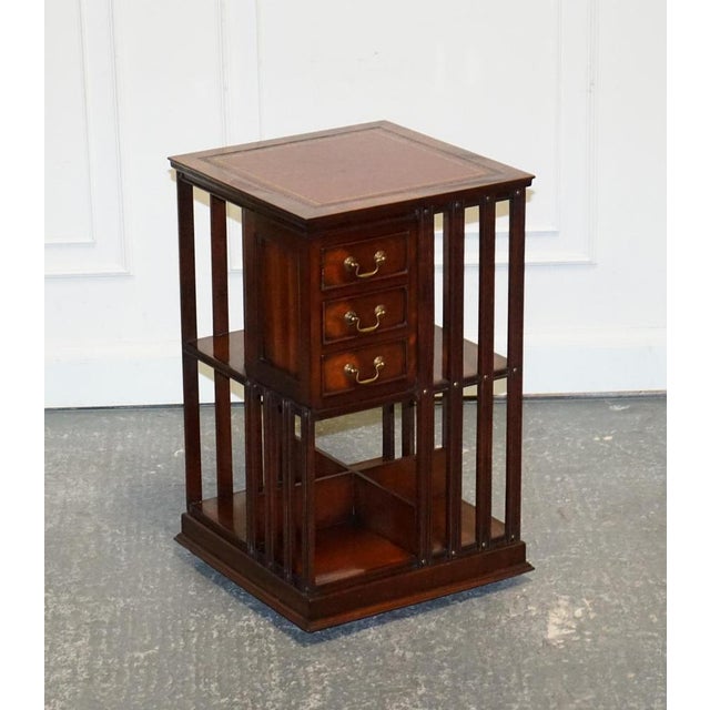 Stunning Revival Inlaid Revolving Bookcase End Table. It is a captivating blend of elegance and functionality, featuring a...