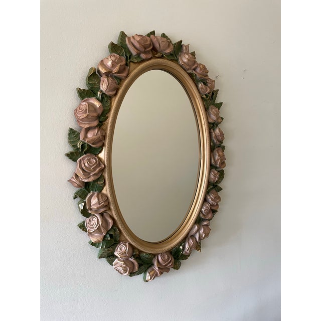 A decorative French Country Revival mirror from the late 1980s, designed with a full surround of sculpted roses and leaves...