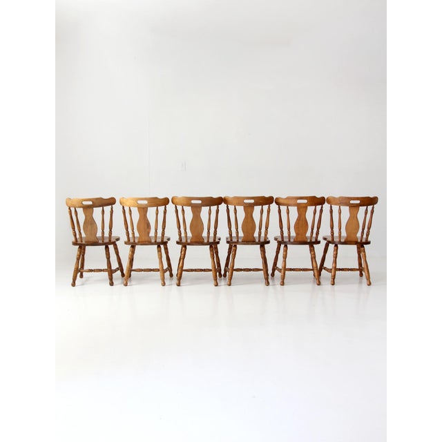 A refined set of six vintage dining chairs in the Colonial Revival tradition, distinguished by graceful proportions and...