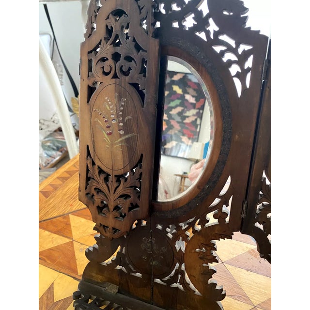 This is a wonderful 19th century Triptych Mirror On the very top two figures playing their horns. The mirror is made of...