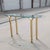 Vintage Brass and Glass Console Table. A slender vintage console table with a beveled glass top and polished brass-toned...